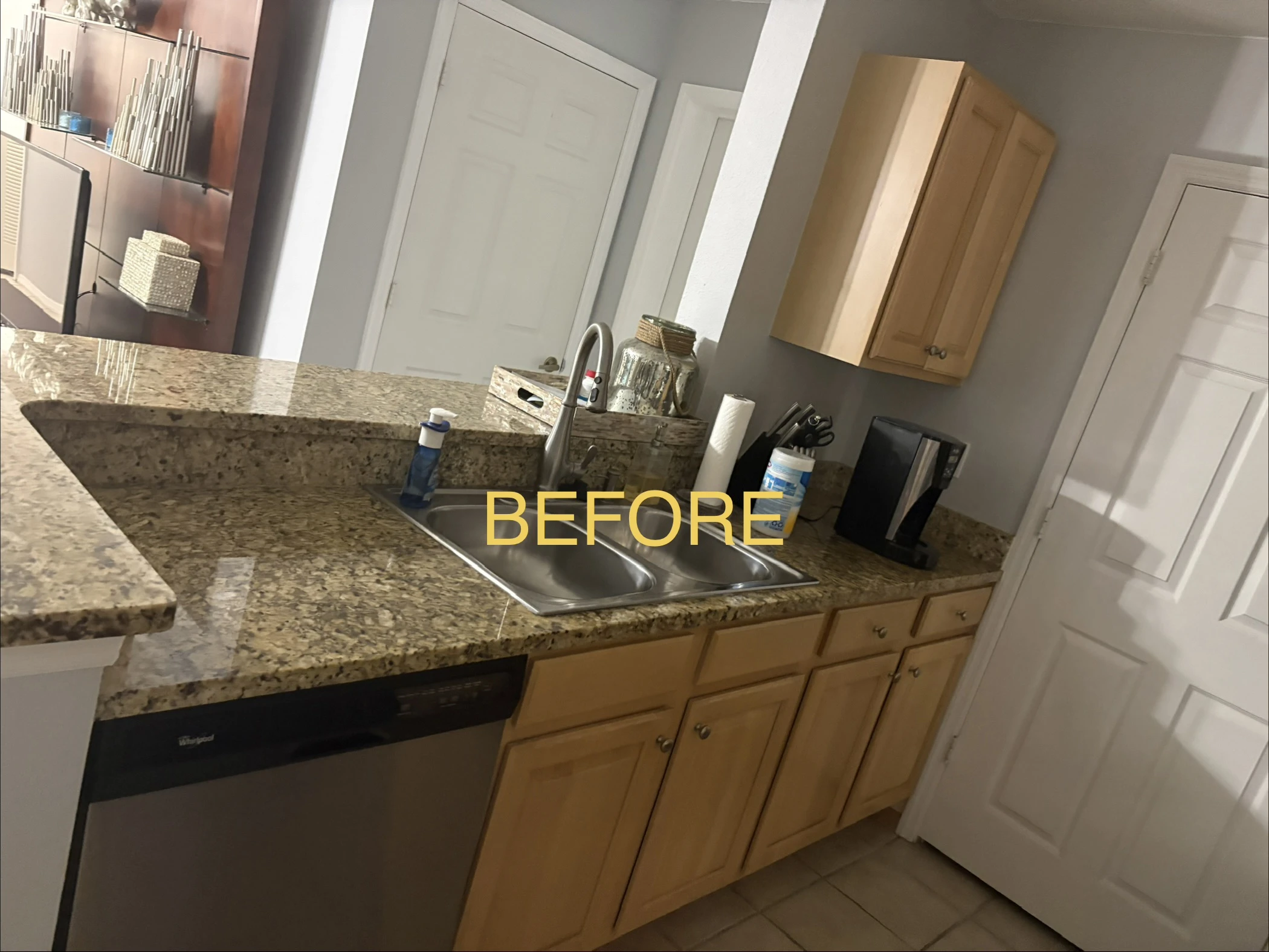 Kitchen before refinishing showing natural wood cabinets and breakfast bar
