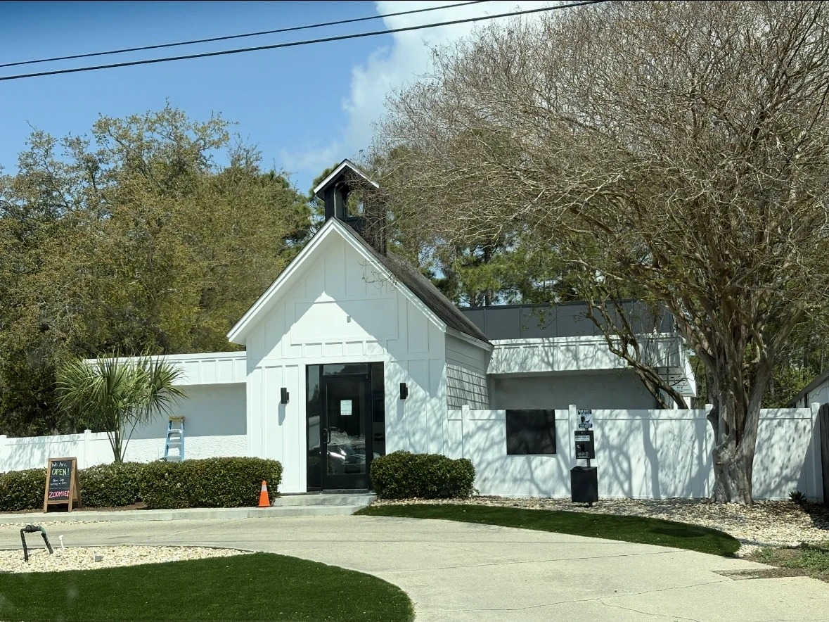 Zoomies Pet Hotel and Daycare after commercial exterior repaint in crisp architectural white with dark trim accents